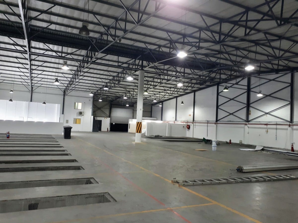 Repainted warehouse interior in Milnerton, white walls and steel roof structure complete