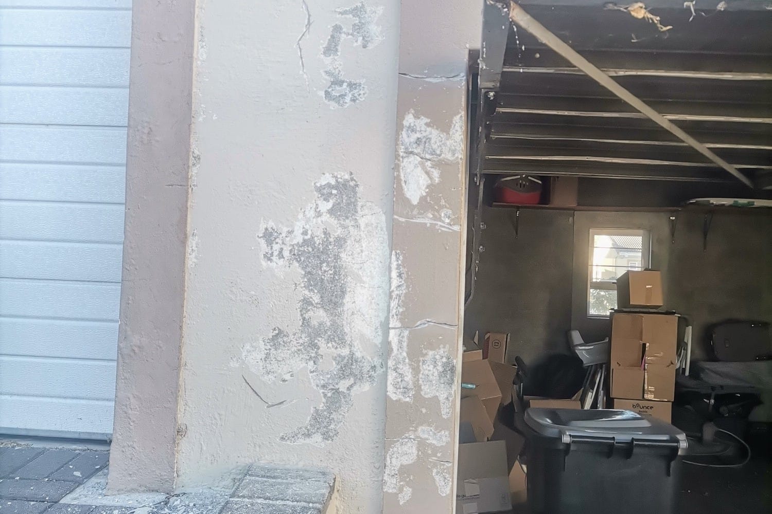 Garage door pillar in Somerset West with paint flaking off and cracks in the plaster