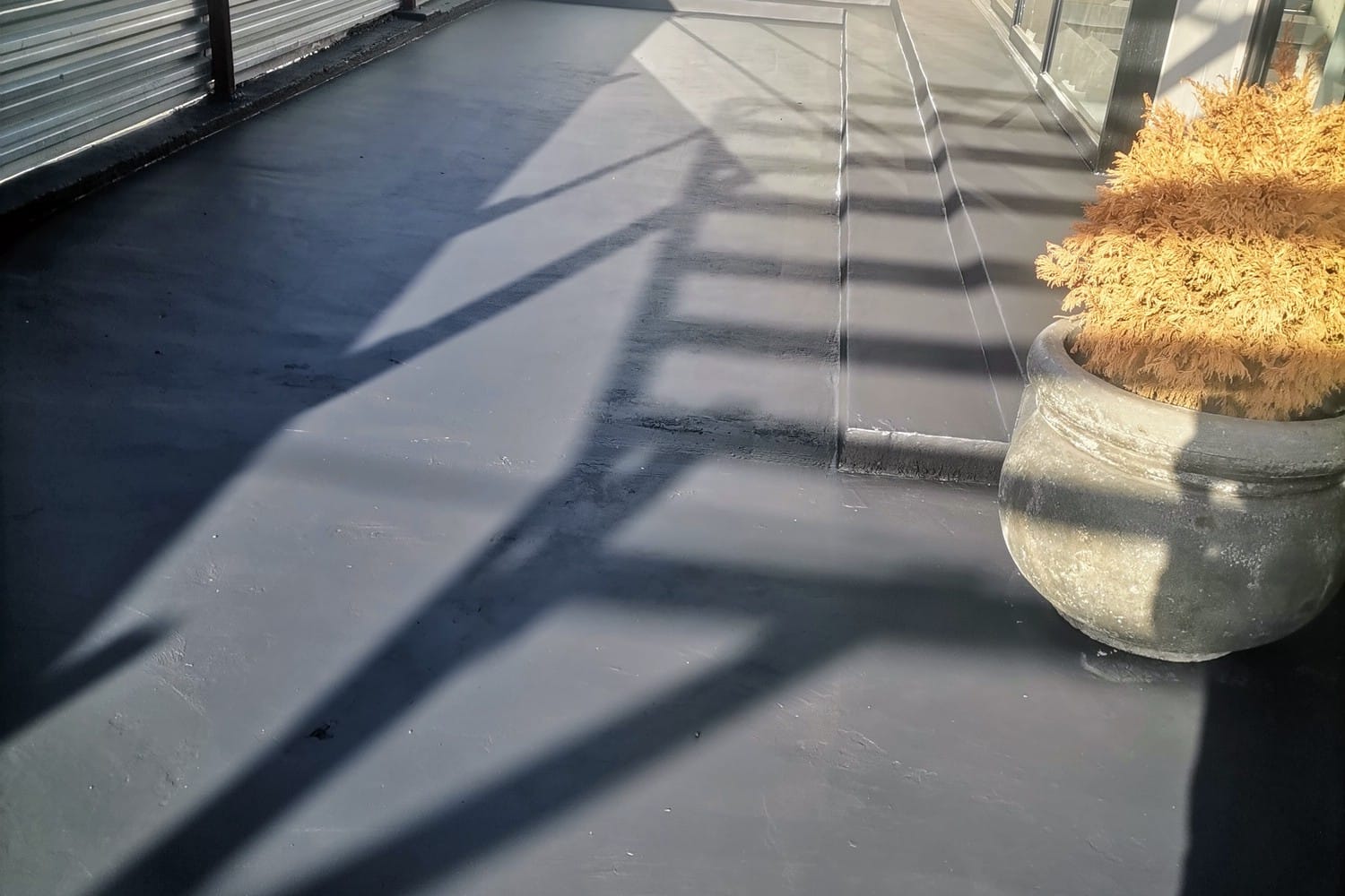 The same Strand courtyard floor coated in two coats of dark grey