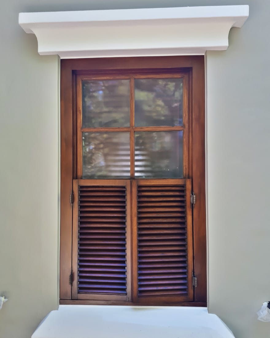 Varnished wooden window frame and shutters, finished in fine detail